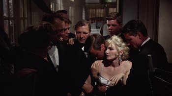 Movie still from “Splendor in the Grass” (1961), directed by Elia Kazan – A group of people standing next to each other in a room; Medium shot, Over the shoulder angle