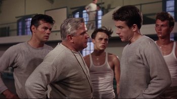 Movie still from “Splendor in the Grass” (1961), directed by Elia Kazan – A group of men standing next to each other in a room; Medium shot, Low angle