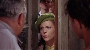 Movie still from “Splendor in the Grass” (1961), directed by Elia Kazan – A woman in a green hat looking out of a window; Close Up shot, Over the shoulder angle
