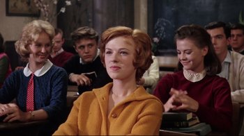 Movie still from “Splendor in the Grass” (1961), directed by Elia Kazan – A woman sitting in front of a group of people; Medium shot, Low angle