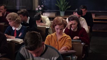 Movie still from “Splendor in the Grass” (1961), directed by Elia Kazan – A group of people sitting at a table; Medium shot, High angle