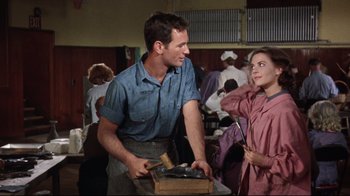 Movie still from “Splendor in the Grass” (1961), directed by Elia Kazan – A man and a woman are standing next to each other; Medium shot, Over the shoulder angle