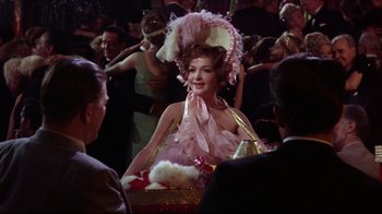 Movie still from “Splendor in the Grass” (1961), directed by Elia Kazan – A woman wearing a pink dress and a pink hat; Medium shot, Over the shoulder angle