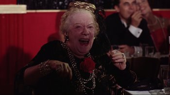 Movie still from “Splendor in the Grass” (1961), directed by Elia Kazan – An older woman with a rose in her mouth; Close Up shot, Over the shoulder angle