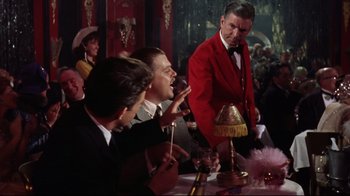 Movie still from “Splendor in the Grass” (1961), directed by Elia Kazan – A group of men sitting at a table with drinks; Medium shot, Over the shoulder angle