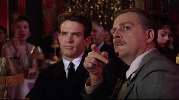 Movie still from “Splendor in the Grass” (1961), directed by Elia Kazan – Two men in suits and ties are looking at something; Medium shot, Over the shoulder angle