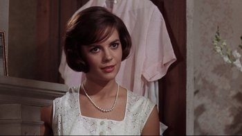 Movie still from “Splendor in the Grass” (1961), directed by Elia Kazan – A young woman in a white dress with a pearl necklace; Close Up shot, Over the shoulder angle