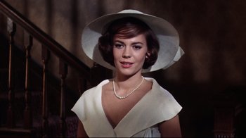 Movie still from “Splendor in the Grass” (1961), directed by Elia Kazan – A woman wearing a white hat and a white dress; Close Up shot, Low angle