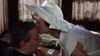 A man and a woman kissing on the forehead