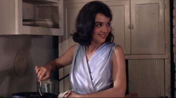 Movie still from “Splendor in the Grass” (1961), directed by Elia Kazan – A woman in a blue dress is stirring a pot; Close Up shot, Low angle