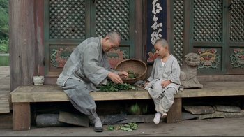 A man sitting next to a boy on a wooden bench