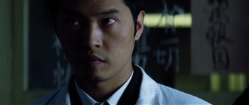 Movie still from “Spy Game” (2001), directed by Tony Scott – A person wearing a shirt and tie; Close Up shot, Low angle