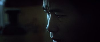 Movie still from “Spy Game” (2001), directed by Tony Scott – A man's face in the dark; Extreme Close Up shot, Low angle