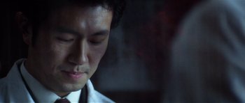 Movie still from “Spy Game” (2001), directed by Tony Scott – A man's face in a dark room; Extreme Close Up shot, Low angle