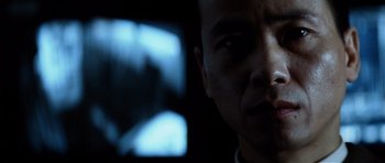 Movie still from “Spy Game” (2001), directed by Tony Scott – A man's face in front of a television; Close Up shot, Low angle