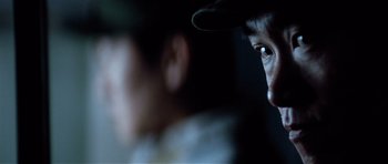 Movie still from “Spy Game” (2001), directed by Tony Scott – A person wearing a hat; Extreme Close Up shot, Over the shoulder angle