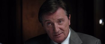 Movie still from “Spy Game” (2001), directed by Tony Scott – A person wearing a suit and tie; Close Up shot, Low angle