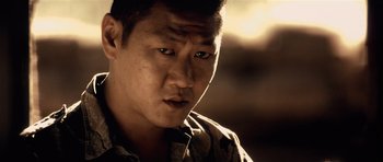 Movie still from “Spy Game” (2001), directed by Tony Scott – A person wearing a camouflage shirt; Close Up shot, Over the shoulder angle