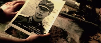 Movie still from “Spy Game” (2001), directed by Tony Scott – An old photo of a man in a military uniform; Extreme Close Up shot, High angle
