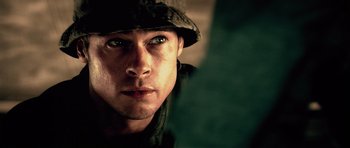 Movie still from “Spy Game” (2001), directed by Tony Scott – A person wearing a hat; Close Up shot, Over the shoulder angle