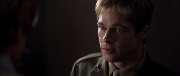 Movie still from “Spy Game” (2001), directed by Tony Scott – A person wearing a military uniform; Close Up shot, Over the shoulder angle