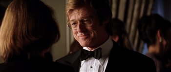 Movie still from “Spy Game” (2001), directed by Tony Scott – A person wearing a suit and bow tie; Close Up shot, Over the shoulder angle