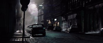 Movie still from “Spy Game” (2001), directed by Tony Scott – Cars parked on the side of the street at night; Wide shot, High angle