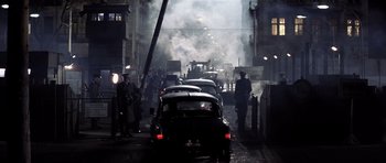 Movie still from “Spy Game” (2001), directed by Tony Scott – A street filled with lots of smoke and cars; Wide shot, High angle