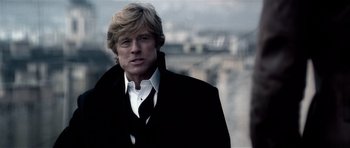 Movie still from “Spy Game” (2001), directed by Tony Scott – A person wearing a suit and tie; Close Up shot, Low angle