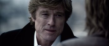 Movie still from “Spy Game” (2001), directed by Tony Scott – A person wearing a white shirt; Close Up shot, Over the shoulder angle