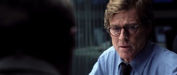 Movie still from “Spy Game” (2001), directed by Tony Scott – A person wearing glasses; Close Up shot, Over the shoulder angle