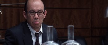 Movie still from “Spy Game” (2001), directed by Tony Scott – A man sitting in front of two wine glasses; Close Up shot, Over the shoulder angle