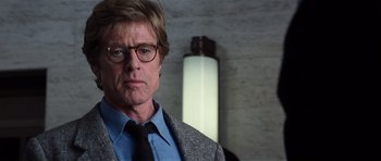 Movie still from “Spy Game” (2001), directed by Tony Scott – A person wearing a suit and tie; Close Up shot, Low angle