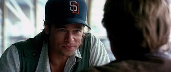 Movie still from “Spy Game” (2001), directed by Tony Scott – A person wearing a baseball cap; Close Up shot, Over the shoulder angle