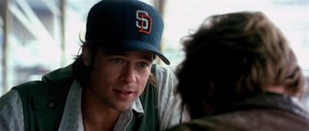 Movie still from “Spy Game” (2001), directed by Tony Scott – A person wearing a baseball cap; Close Up shot, Over the shoulder angle