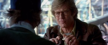 Movie still from “Spy Game” (2001), directed by Tony Scott – An older man wearing glasses talking to a younger man; Close Up shot, Over the shoulder angle