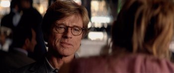 Movie still from “Spy Game” (2001), directed by Tony Scott – A person wearing glasses; Close Up shot, Over the shoulder angle