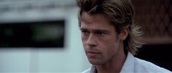 Movie still from “Spy Game” (2001), directed by Tony Scott – A person wearing a white shirt; Close Up shot, Over the shoulder angle