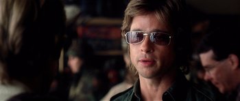 Movie still from “Spy Game” (2001), directed by Tony Scott – A person wearing sunglasses; Close Up shot, Over the shoulder angle