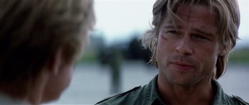 Movie still from “Spy Game” (2001), directed by Tony Scott – A man with long blonde hair is talking to another man; Close Up shot, Over the shoulder angle