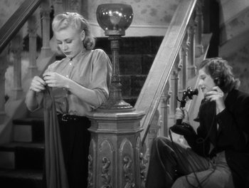 Movie still from “Stage Door” (1937), directed by Gregory La Cava – Two women sitting on a stair case looking at a camera; Medium shot, High angle