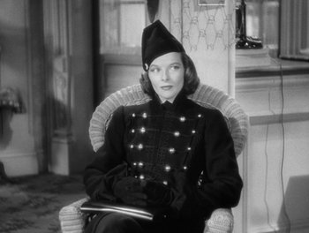 Movie still from “Stage Door” (1937), directed by Gregory La Cava – A black and white photo of a woman sitting in a chair; Medium shot, Low angle
