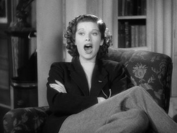 Movie still from “Stage Door” (1937), directed by Gregory La Cava – A woman sitting on a couch with her mouth open; Close Up shot, Low angle