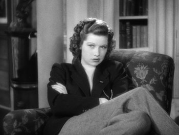 Movie still from “Stage Door” (1937), directed by Gregory La Cava – A black and white photo of a woman sitting on a couch; Medium shot, High angle