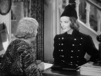 Movie still from “Stage Door” (1937), directed by Gregory La Cava – An old photo of a woman talking to another woman; Medium shot, Over the shoulder angle