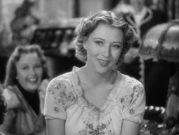 Movie still from “Stage Door” (1937), directed by Gregory La Cava – A black - and - white photo of a woman smiling; Close Up shot, Over the shoulder angle