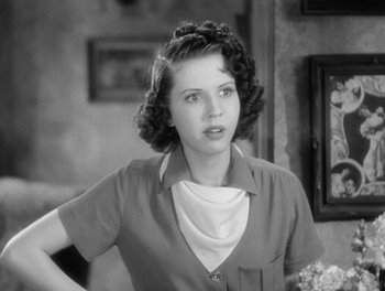 Movie still from “Stage Door” (1937), directed by Gregory La Cava – A young woman in a short skirt and a white shirt; Close Up shot, Low angle