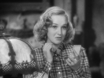 Movie still from “Stage Door” (1937), directed by Gregory La Cava – A black and white photo of a woman holding a mirror; Close Up shot, High angle