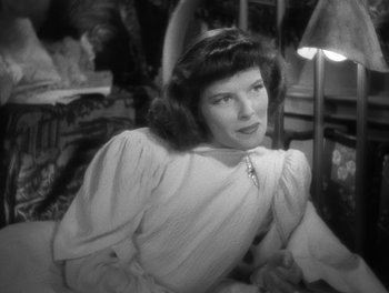 Movie still from “Stage Door” (1937), directed by Gregory La Cava – An old black and white photo of a woman sitting in a chair; Close Up shot, Low angle