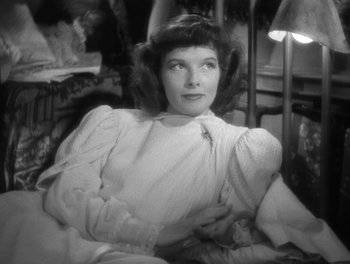 Movie still from “Stage Door” (1937), directed by Gregory La Cava – An old black and white photo of a woman sitting in a chair; Close Up shot, High angle